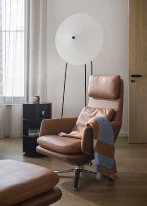 Výrazná stojací lampa Rificolona s působivým stínidlem z recyklovaného materiálu ve dne působí jako designový prvek a večer proměňuje prostor svým hřejivým tlumeným světlem. Výběr křesla představoval velké téma, byla od něj požadována sklopná mechanika a vyšší zádová opěrka.